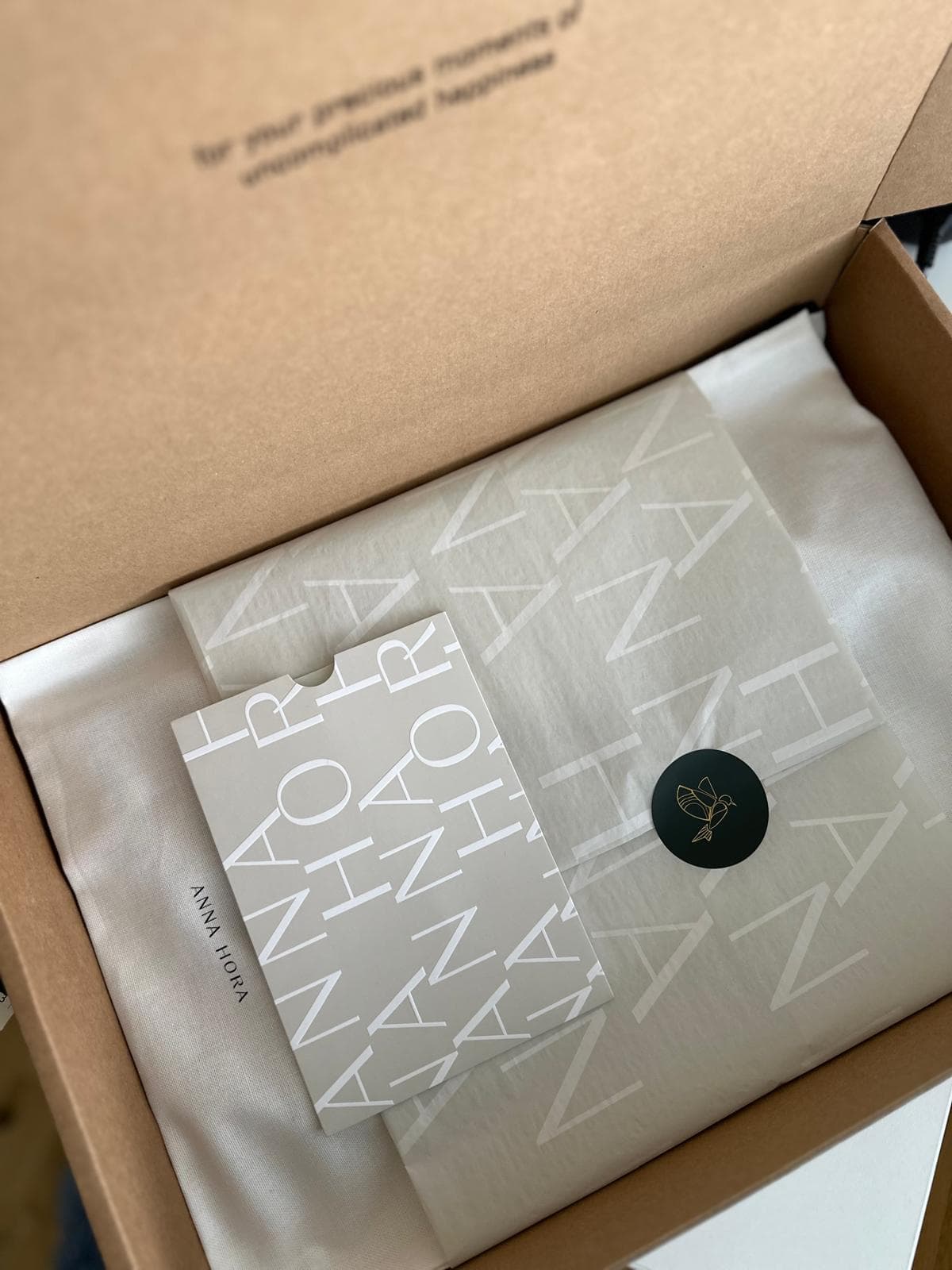 An ANNA HORA order packed in branded tissue and packaging with a sealed sticker.